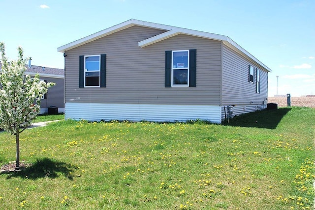 view of side of home featuring a yard