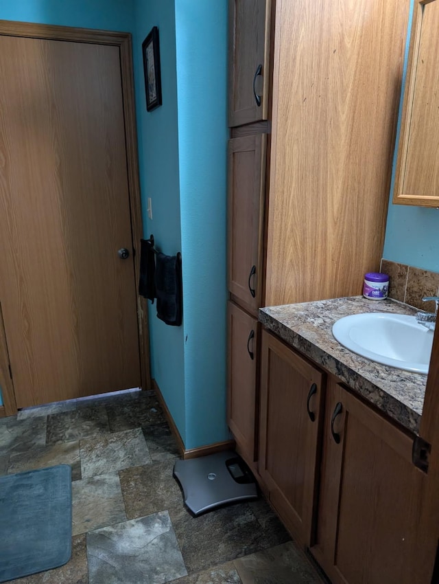 2013 Peregrine Pl NW, Stewartville, MN 55976 - bathroom with stone finish floor, baseboards, and vanity