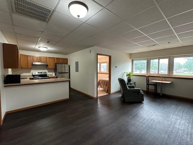 kitchen featuring kitchen peninsula, electric panel, a drop ceiling, stainless steel appliances, and dark hardwood / wood-style floors