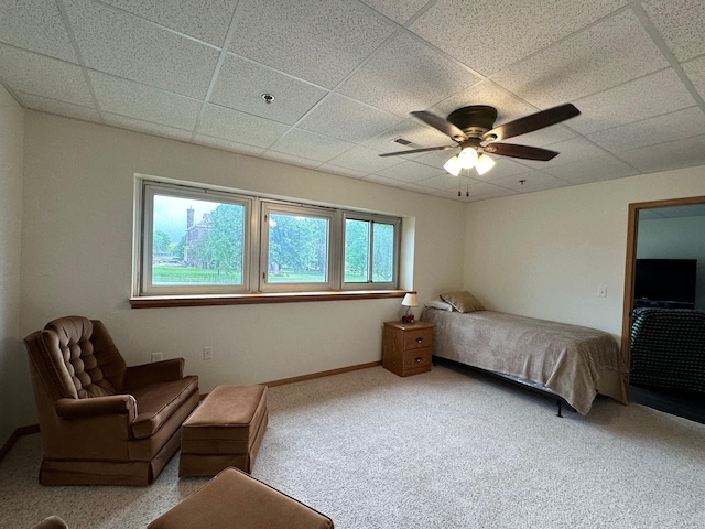 bedroom with a paneled ceiling, ceiling fan, and carpet floors