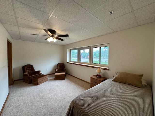 unfurnished bedroom with a paneled ceiling, ceiling fan, and carpet floors