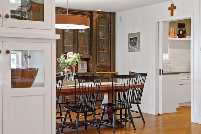 dining space with light hardwood / wood-style floors