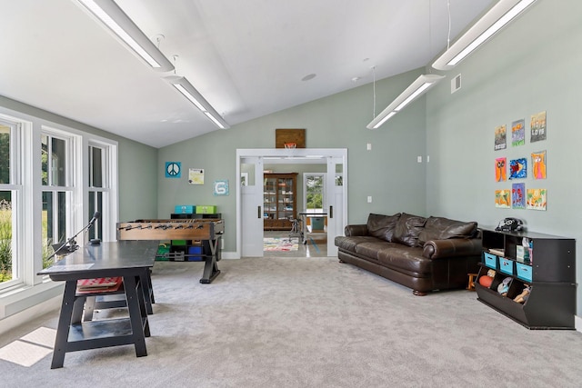 carpeted living room featuring vaulted ceiling