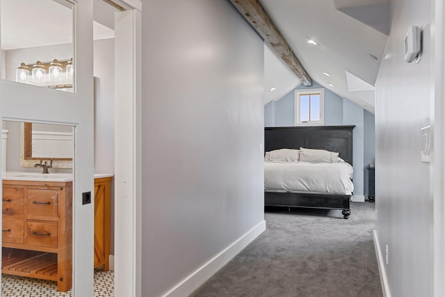 bedroom featuring sink, carpet flooring, and vaulted ceiling with beams