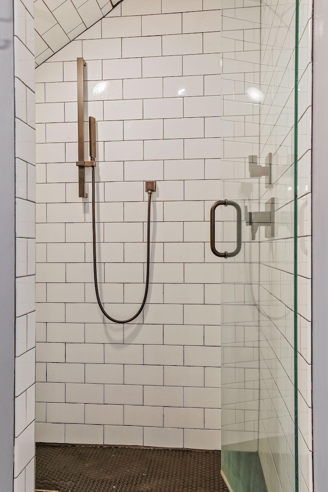 bathroom featuring a shower with shower door