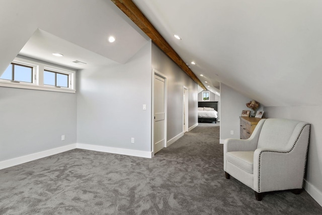 unfurnished room featuring vaulted ceiling with beams and dark colored carpet