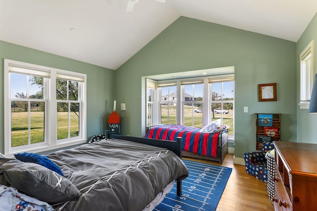 bedroom featuring high vaulted ceiling, ceiling fan, and hardwood / wood-style floors