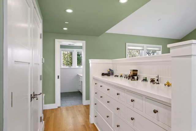 interior space featuring lofted ceiling and light wood-type flooring