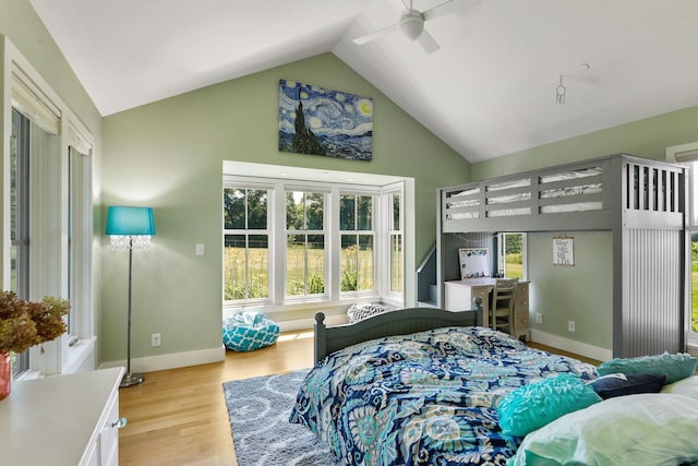 bedroom with high vaulted ceiling, ceiling fan, and light hardwood / wood-style flooring