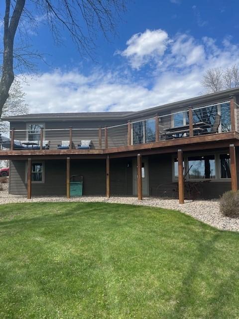 back of property with a lawn