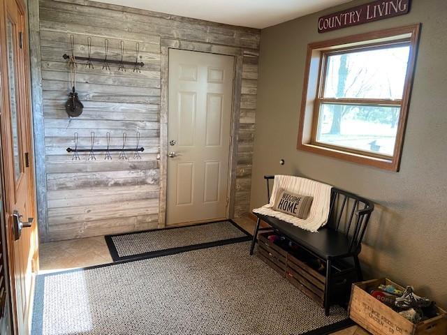 entryway featuring wooden walls