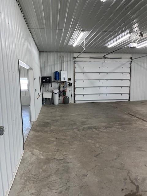 garage featuring water heater and sink