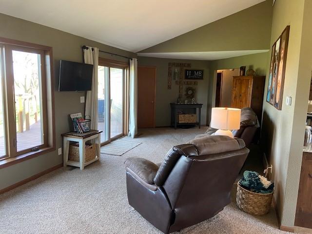 living room with light colored carpet and lofted ceiling