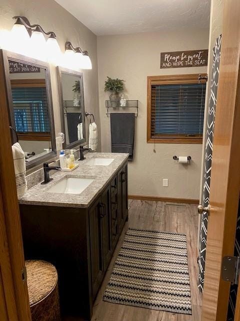 bathroom with hardwood / wood-style floors and double sink vanity