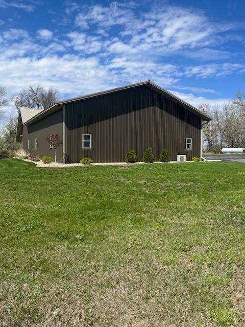view of side of property with a lawn