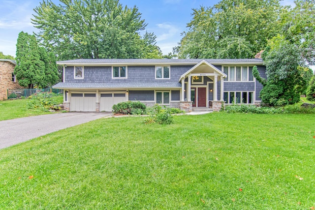 bi-level home featuring a front yard and a garage