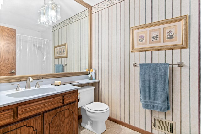 bathroom featuring tile patterned floors, a shower with curtain, vanity, and toilet