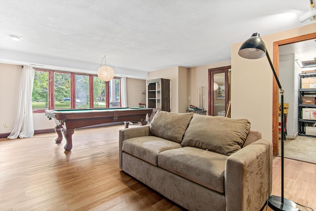 recreation room with light hardwood / wood-style floors, a textured ceiling, and billiards