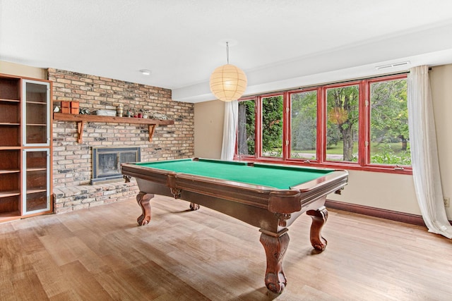 game room featuring a fireplace, billiards, and light hardwood / wood-style flooring