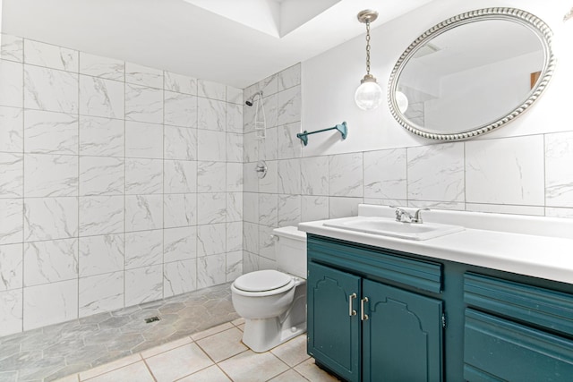 bathroom featuring vanity, toilet, tile walls, and walk in shower