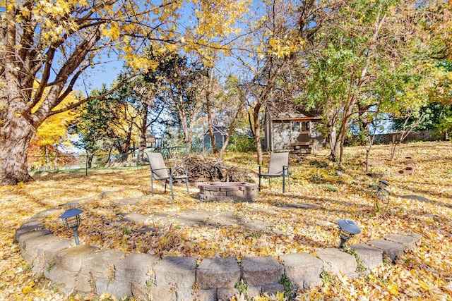 view of yard featuring an outdoor fire pit