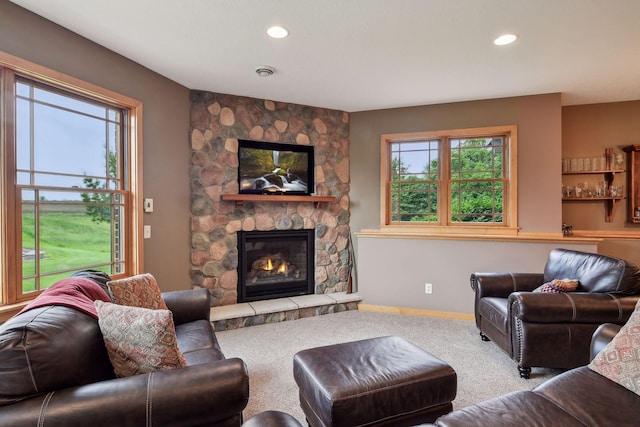 carpeted living room with a healthy amount of sunlight and a fireplace