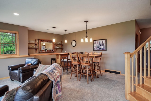 carpeted dining space with indoor bar