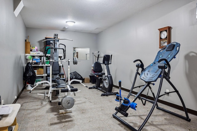 workout room with a textured ceiling