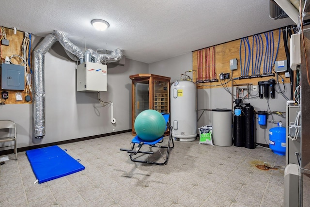 exercise room with a textured ceiling, water heater, and electric panel