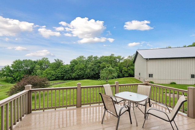 wooden deck with a lawn