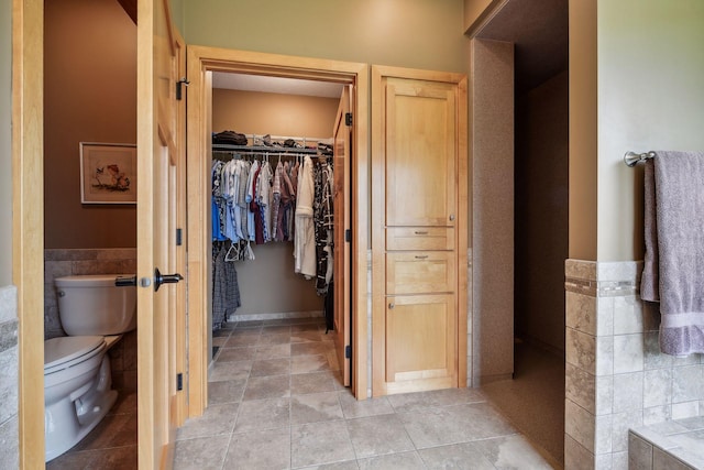 bathroom featuring tile patterned floors and toilet