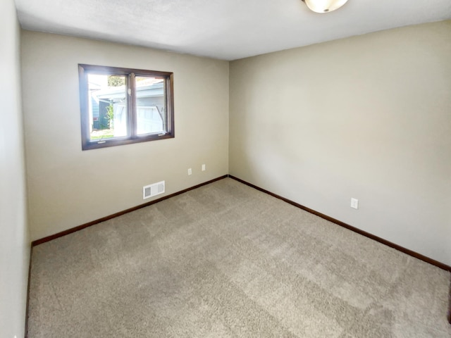 unfurnished room featuring light colored carpet