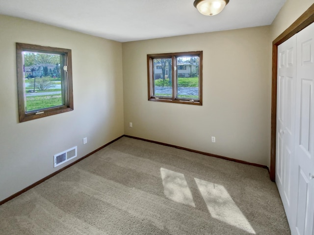 unfurnished bedroom featuring carpet and a closet