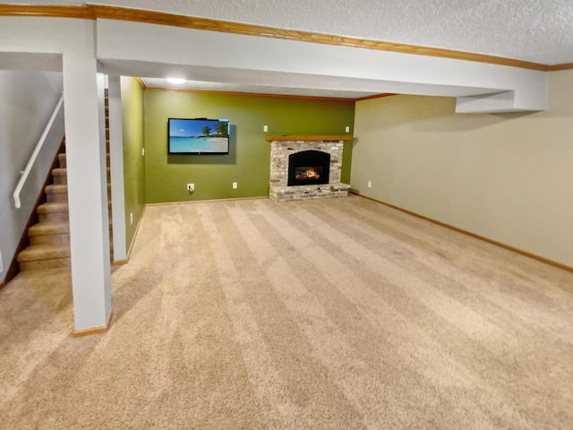 unfurnished living room featuring carpet flooring, a textured ceiling, and a stone fireplace