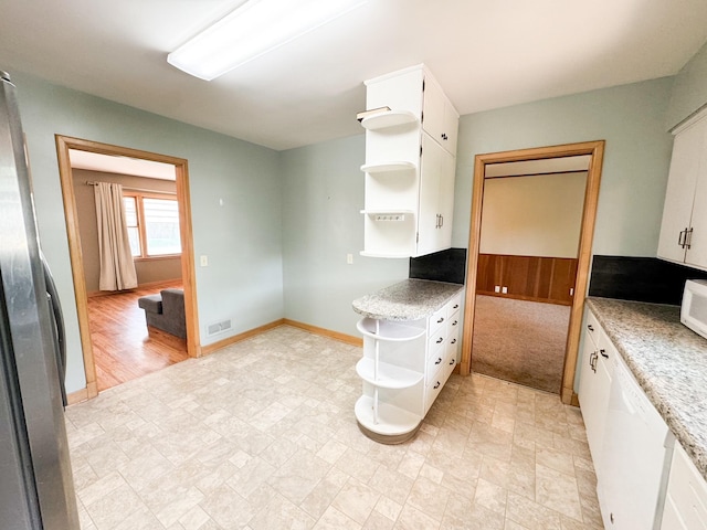 kitchen featuring white cabinetry and white appliances