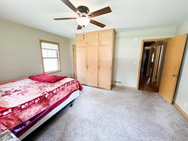 carpeted bedroom with ceiling fan