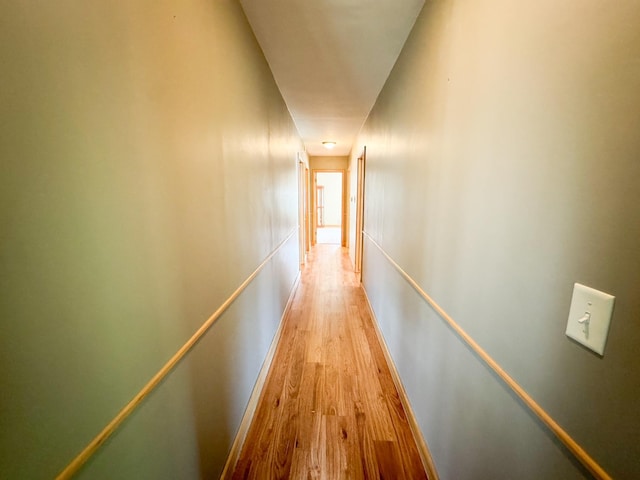 hallway with light hardwood / wood-style floors