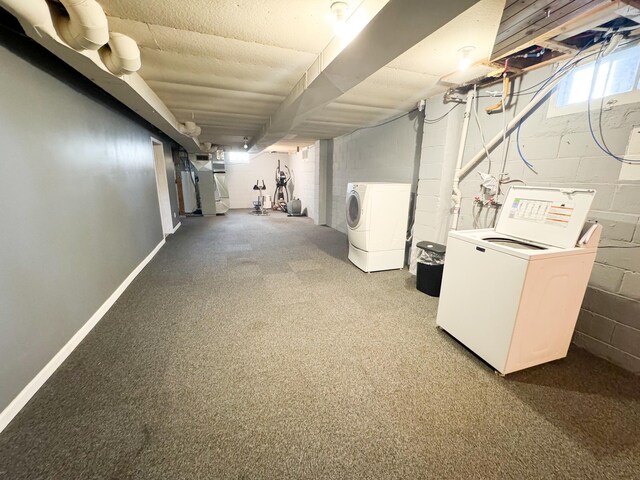 basement featuring heating unit and washer and clothes dryer