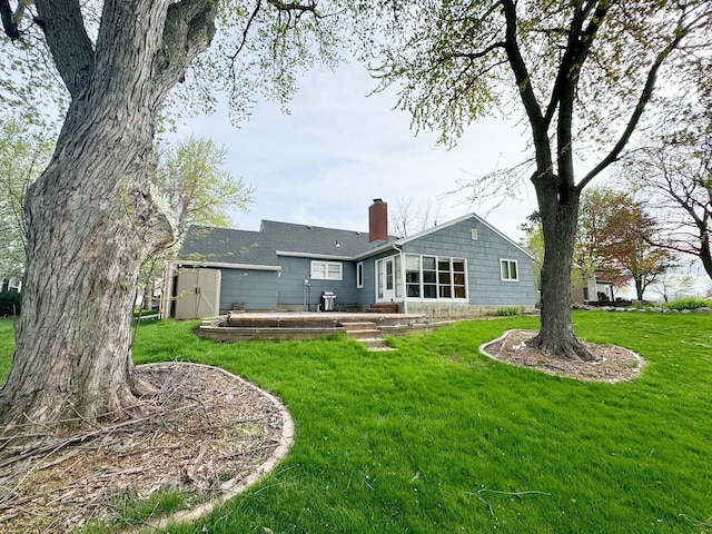 rear view of property with a lawn