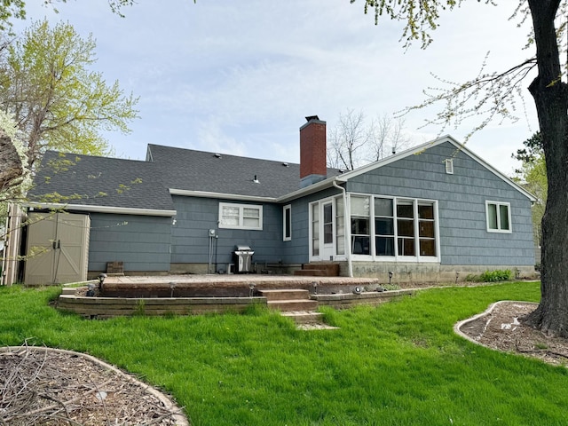 rear view of house with a yard