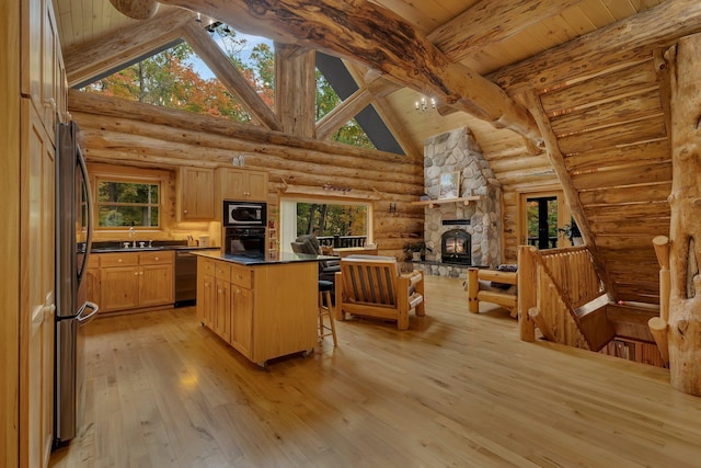 kitchen featuring light hardwood / wood-style flooring, log walls, black appliances, and beam ceiling