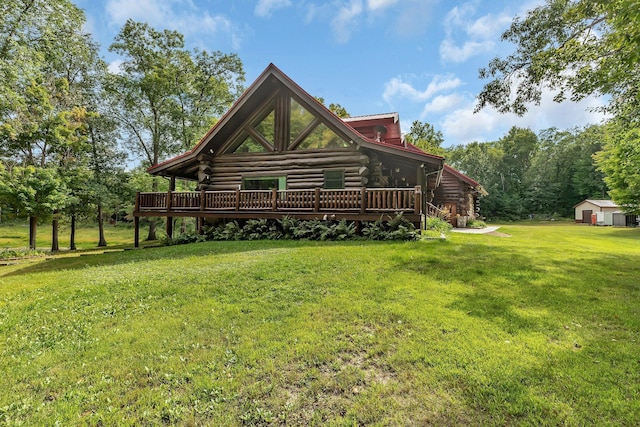 view of property exterior featuring a deck, a storage unit, and a lawn