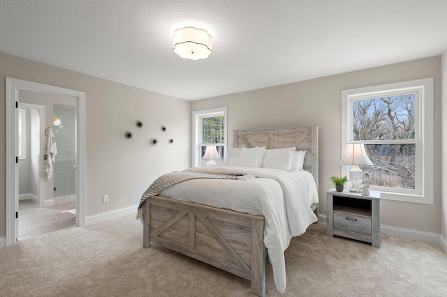 carpeted bedroom featuring ensuite bath