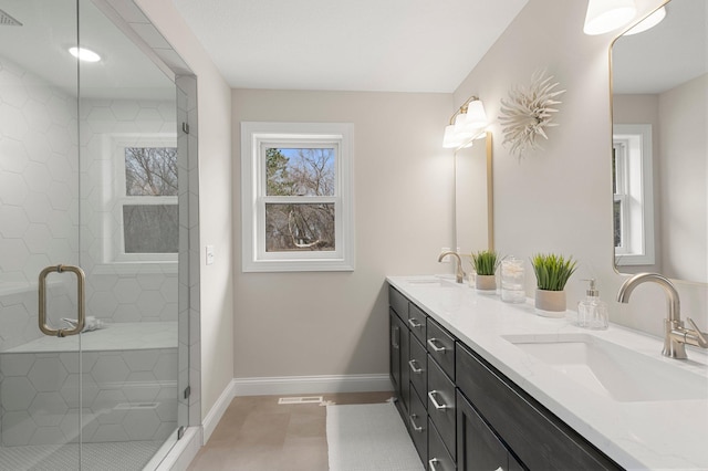 bathroom with walk in shower, dual bowl vanity, and tile flooring