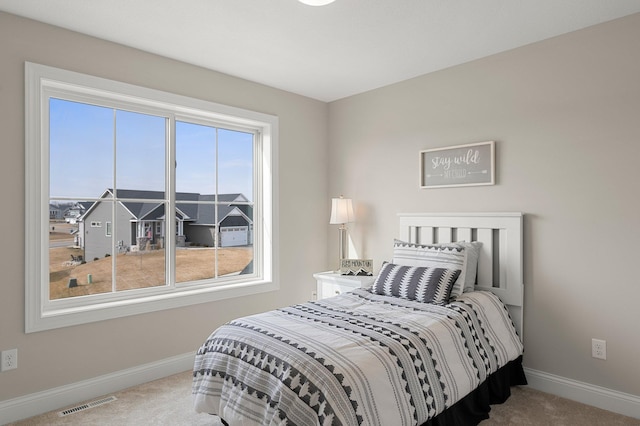 bedroom featuring carpet and multiple windows