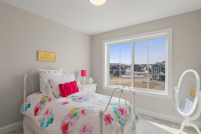 bedroom with carpet flooring and multiple windows