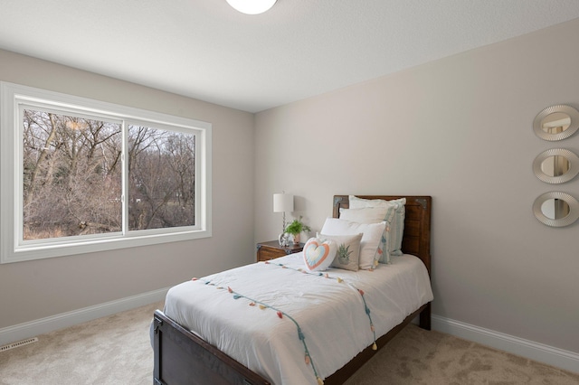 carpeted bedroom with multiple windows