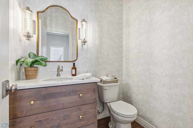 bathroom featuring vanity, toilet, and wood-type flooring