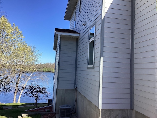 view of side of home featuring central AC unit