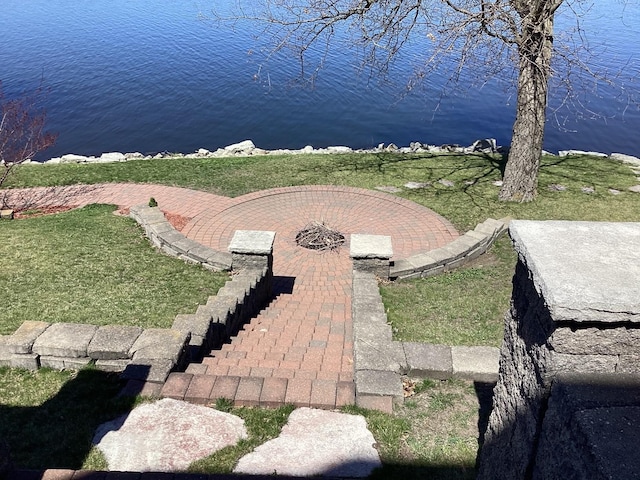 surrounding community featuring a water view and a lawn